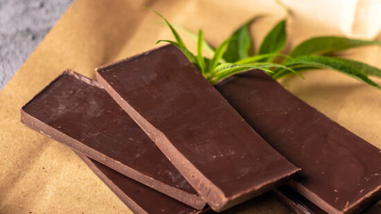 Vegan dark  chocolate with cannabis leaves. Desert with CBD butter. Medicinal marijuana in food, vegan, supplements consept