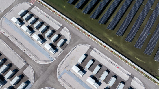 Aerial view of a solar power plant with energy storage facilities and photovoltaic panel arrays