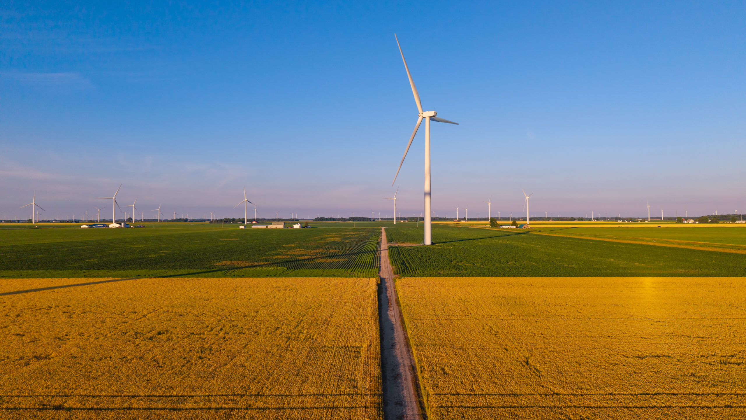 Wind turbines generating clean energy in vast agricultural field